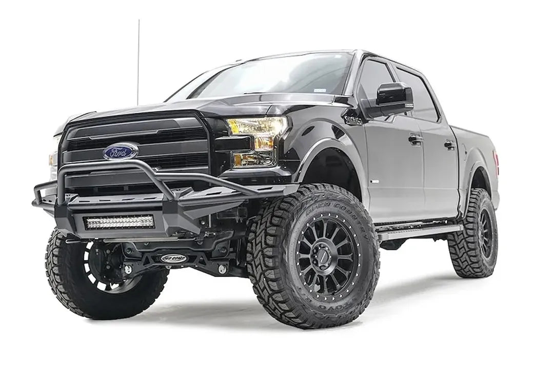 Fab Fours Aero front bumper on a black Ford F-150, front driver-side three-quarter studio view, showing the tubular hoop, slim bumper frame and light bar