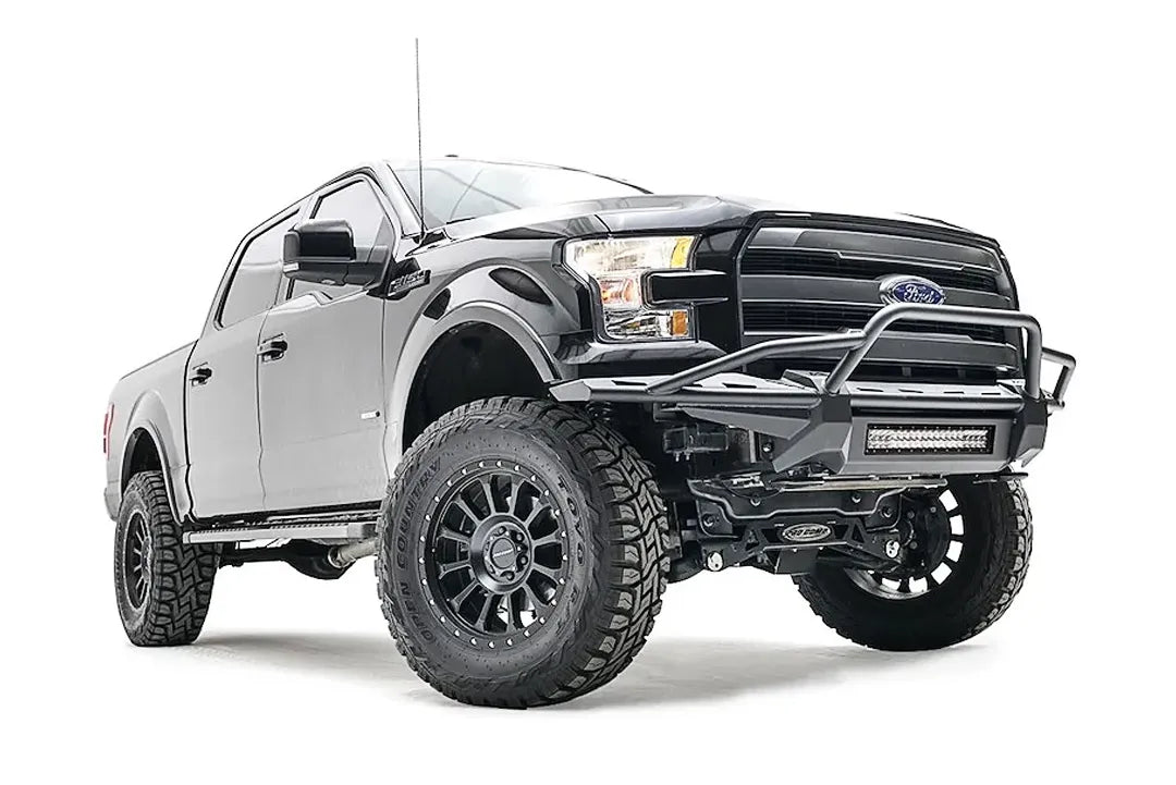 Fab Fours Aero front bumper on a black Ford F-150, front passenger-side three-quarter studio view, showing the tubular hoop, slim bumper frame and light bar