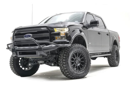 Fab Fours Aero front bumper with pre-runner guard on a black Ford F-150, front driver-side three-quarter studio view, showing the pre-runner hoop, slim bumper frame and light bar