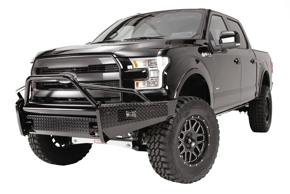 Fab Fours Black Steel front bumper with pre-runner guard on a black Ford F-150, front driver-side three-quarter studio view, showing the pre-runner hoop, diamond-plate bumper and wraparound wings