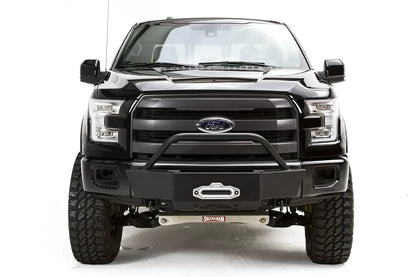 Fab Fours winch mount on a black Ford F-150, straight-on front studio view, showing the pre-runner hoop, winch fairlead and low-profile front plate