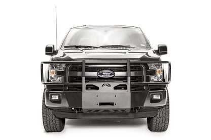 Fab Fours winch mount with full guard on a gray Ford F-150, straight-on front studio view, showing the full grille guard, center winch plate and skid section
