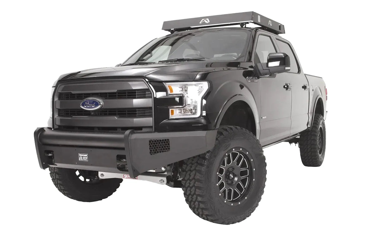 Fab Fours Black Steel Elite front bumper on a black Ford F-150, front driver-side three-quarter studio view, showing the smooth bumper face, tubular top rail and side mesh vents