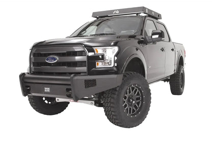 Fab Fours Black Steel Elite front bumper on a black Ford F-150, front driver-side three-quarter studio view, showing the smooth bumper face, tubular top rail and side mesh vents