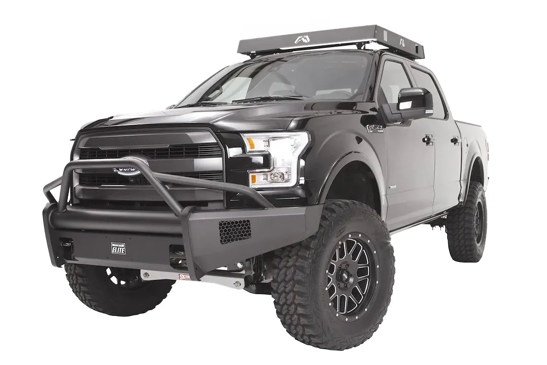 Fab Fours Black Steel Elite front bumper with pre-runner guard on a black Ford F-150, front driver-side three-quarter studio view, showing the pre-runner hoop, smooth bumper face and side mesh vents