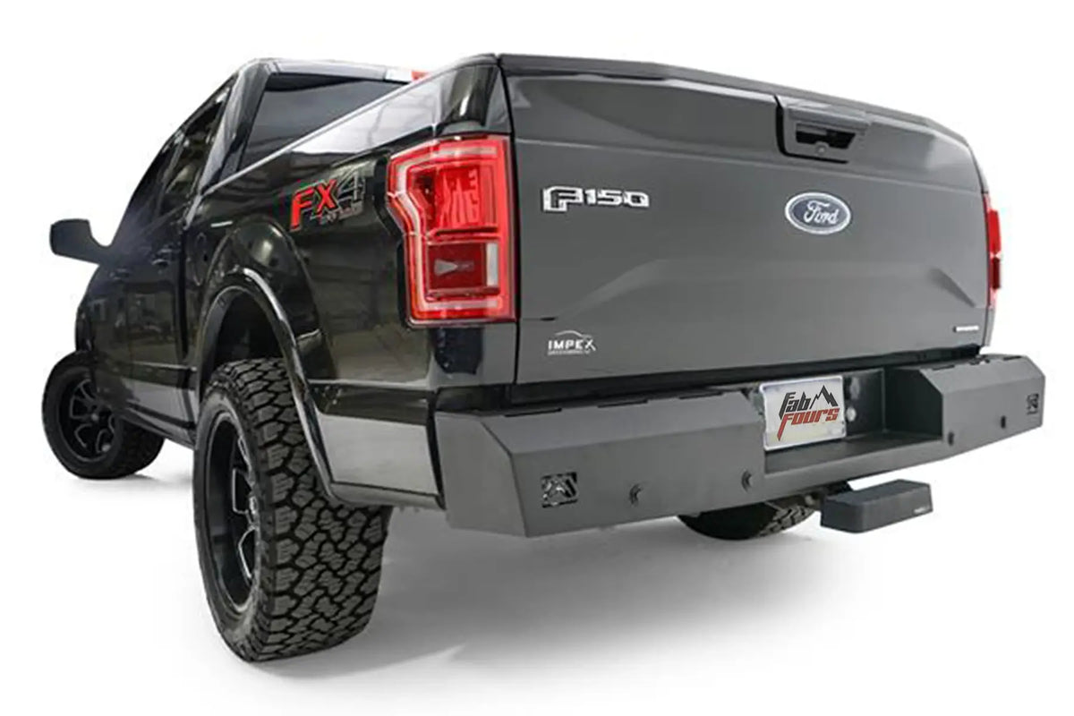 Fab Fours Red Steel rear bumper on a dark gray Ford F-150, rear driver-side three-quarter view, showing the bumper end cap, corner light and receiver hitch opening