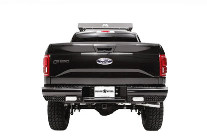 Fab Fours Black Steel rear bumper on a black Ford F-150, straight-on rear view, showing the diamond-plate face, rectangular lights and license plate mount