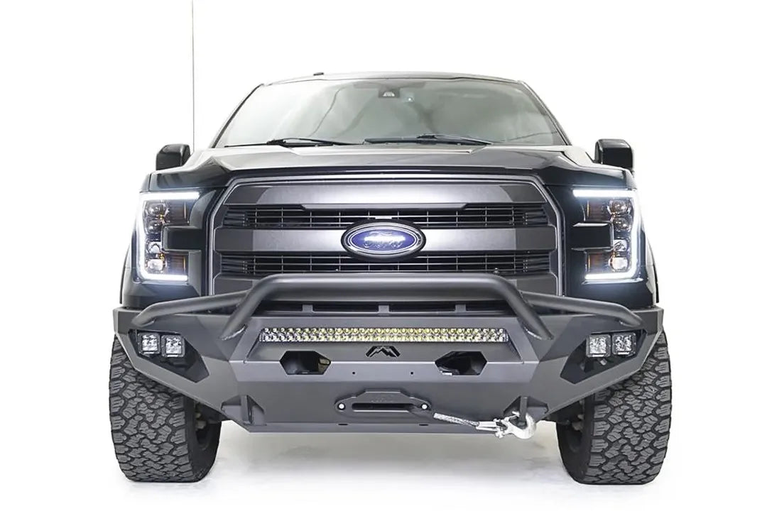 Fab Fours Matrix front bumper with pre-runner guard on a black Ford F-150, straight-on front view, showing the pre-runner hoop, center light bar and winch