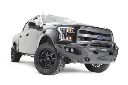 Fab Fours Matrix front bumper with pre-runner guard on a black Ford F-150, front passenger-side three-quarter view, showing the pre-runner hoop, light bar and winch
