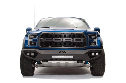 Fab Fours Vengeance front bumper on a blue and gray wrapped Ford Raptor, straight-on front view, showing the center light bar, cube light pods and Fab Fours logo