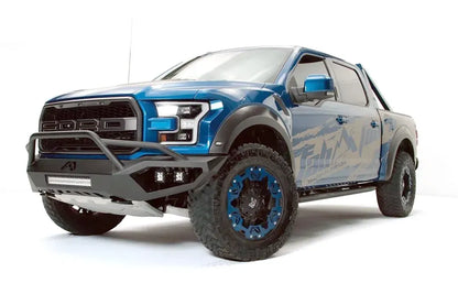 Fab Fours Vengeance front bumper with pre-runner guard on a blue and gray wrapped Ford Raptor, front driver-side three-quarter view, showing the pre-runner hoop, light bar and cube light pods