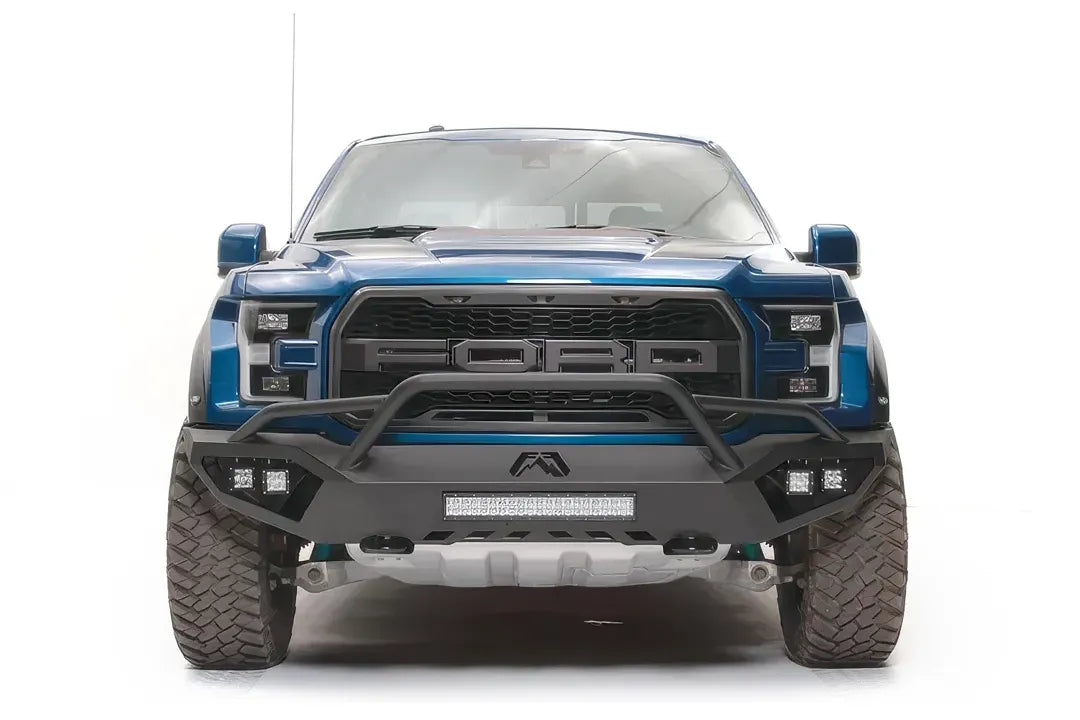 Fab Fours Vengeance front bumper with pre-runner guard on a blue and gray wrapped Ford Raptor, straight-on front view, showing the pre-runner hoop, center light bar and cube light pods