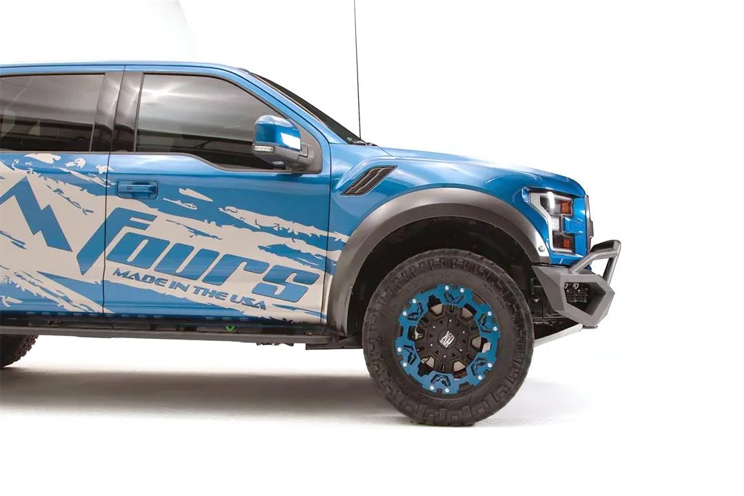 Fab Fours Vengeance front bumper with pre-runner guard on a blue and gray wrapped Ford Raptor, passenger-side profile view, showing the pre-runner tube and bumper end