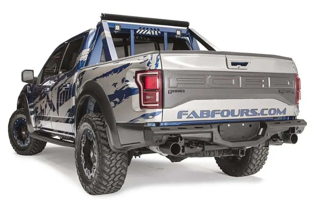 Fab Fours Aero rear bumper on a Ford F-150 Raptor with blue and silver Fab Fours wrap and chase rack, driver-side rear three-quarter view