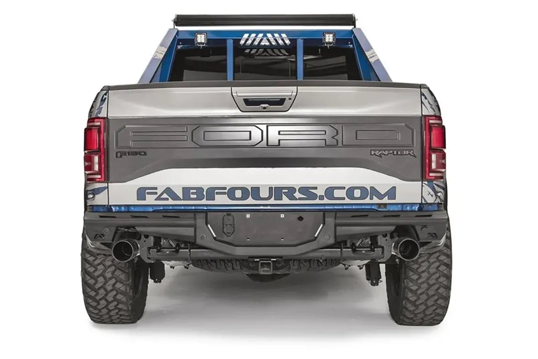 Fab Fours Aero rear bumper on a Ford F-150 Raptor, straight rear view, with center license plate mount, hitch receiver, and dual exhaust tips