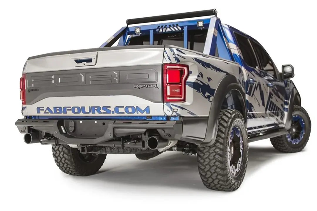 Fab Fours Aero rear bumper on a Ford F-150 Raptor with blue and silver Fab Fours wrap and chase rack, passenger-side rear three-quarter view