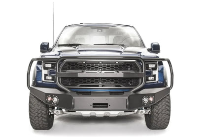 Fab Fours Premium Winch front bumper with full guard on a blue and gray wrapped Ford Raptor, straight-on front view, showing the full grille guard, center winch recess and round fog lights