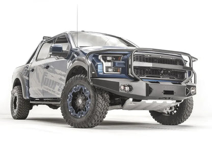 Fab Fours Premium Winch front bumper with full guard on a blue and gray wrapped Ford Raptor, front passenger-side three-quarter view, showing the full grille guard, winch recess and round fog lights