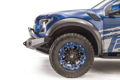 Fab Fours Premium Winch front bumper with pre-runner guard on a blue and gray wrapped Ford Raptor, close-up of the front corner, showing the pre-runner tube, bumper end and shackle mount