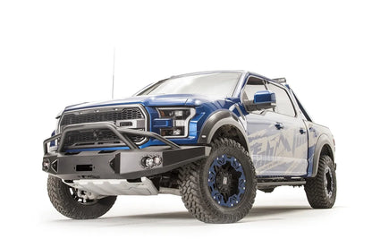 Fab Fours Premium Winch front bumper with pre-runner guard on a blue and gray wrapped Ford Raptor, front driver-side three-quarter view, showing the pre-runner hoop, winch recess and round fog lights