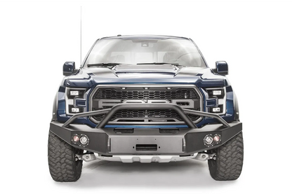 Fab Fours Premium Winch front bumper with pre-runner guard on a blue and gray wrapped Ford Raptor, straight-on front view, showing the pre-runner hoop, center winch recess and round fog lights