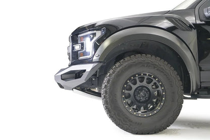 Fab Fours Matrix front bumper on a black Ford Raptor, close-up of the front corner, showing the bumper end cap and wheel clearance