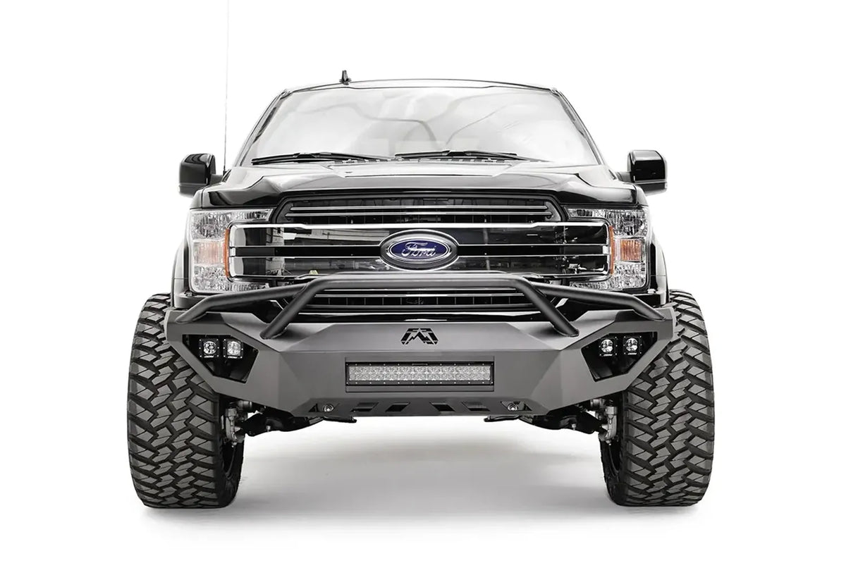 Fab Fours Vengeance front bumper with pre-runner guard on a black Ford F-150, straight-on front view, showing the pre-runner hoop, center light bar and cube light pods