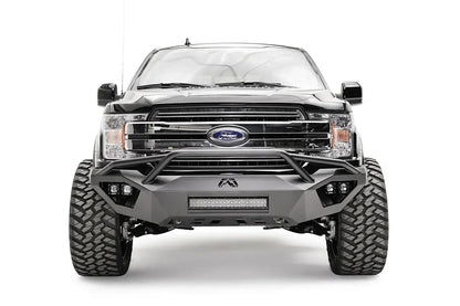 Fab Fours Vengeance front bumper with pre-runner guard on a black Ford F-150, straight-on front view, showing the pre-runner hoop, center light bar and cube light pods