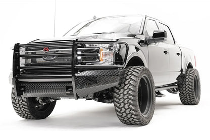 Fab Fours Black Steel front bumper with full guard on a black Ford F-150, front driver-side three-quarter view, showing the full grille guard, diamond-plate face and bumper wings