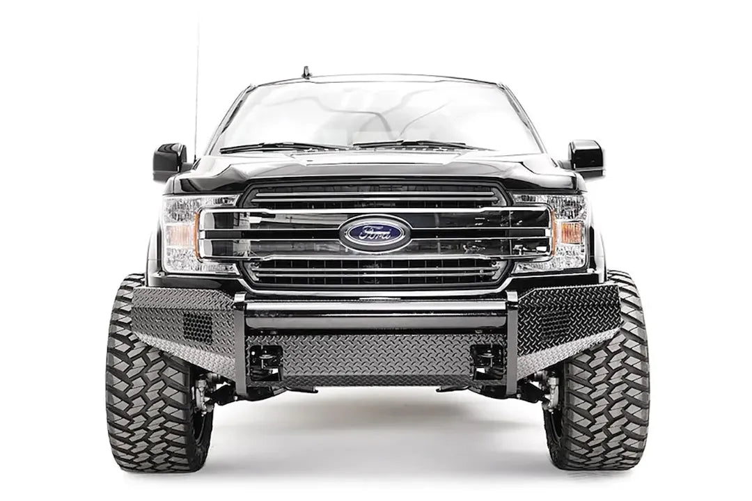Fab Fours Black Steel front bumper on a black Ford F-150, straight-on front view, showing the diamond-plate face, tube top rail and bumper wings