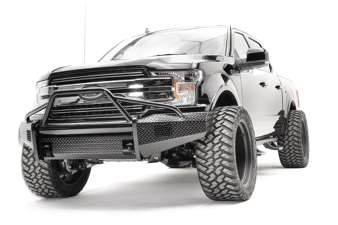 Fab Fours Black Steel front bumper with pre-runner guard on a black Ford F-150, front driver-side three-quarter view, showing the pre-runner hoop, diamond-plate face and bumper wings