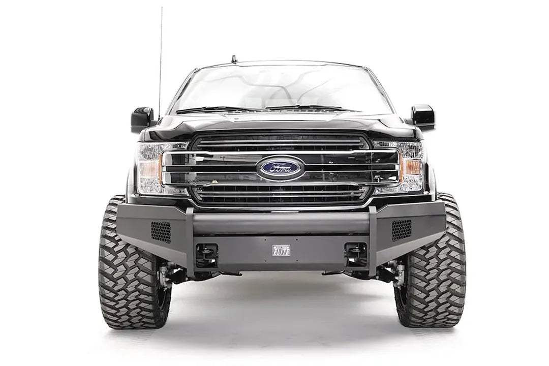 Fab Fours Black Steel Elite front bumper on a black Ford F-150, straight-on front view, showing the smooth bumper face, mesh vents and center plate mount