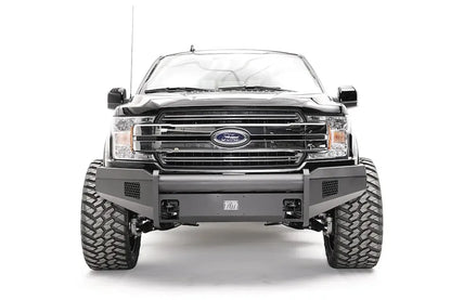 Fab Fours Black Steel Elite front bumper on a black Ford F-150, straight-on front view, showing the smooth bumper face, mesh vents and center plate mount