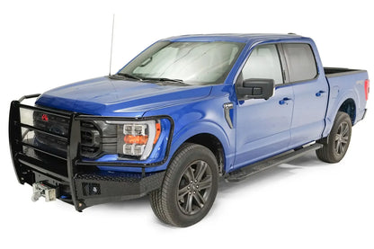 Fab Fours Black Steel front bumper with full guard on a blue Ford F-150, front driver-side three-quarter view, showing the full grille guard, diamond-plate wings and winch
