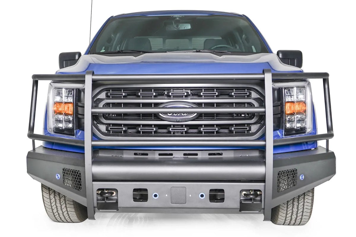 Fab Fours Black Steel Elite front bumper with full guard on a blue Ford F-150, straight-on front view, showing the full grille guard, smooth bumper face and mesh vents