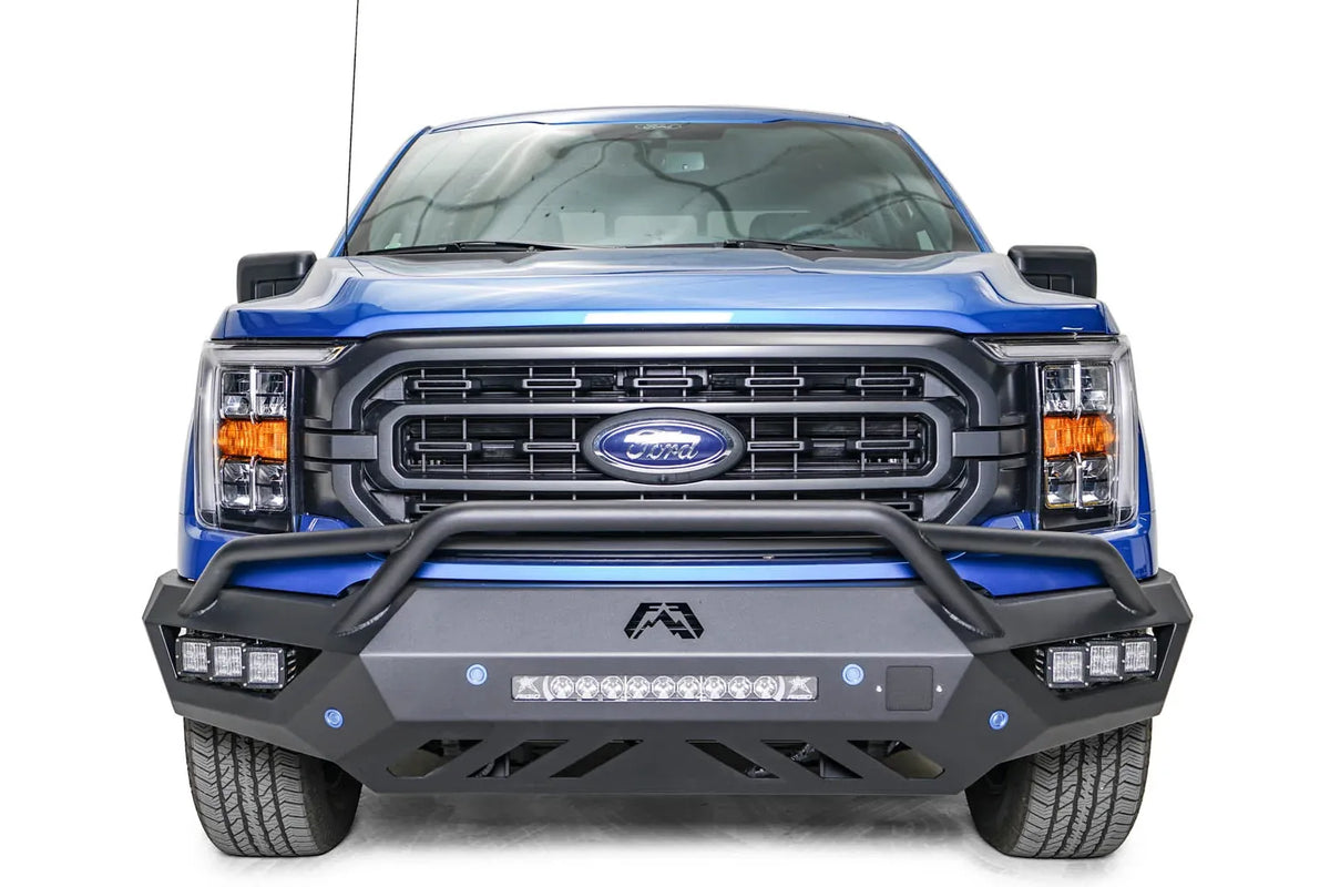 Fab Fours Vengeance front bumper with pre-runner guard on a blue Ford F-150, straight-on front view, showing the pre-runner hoop, center light bar and cube light pods