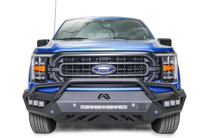 Fab Fours Vengeance front bumper with pre-runner guard on a blue Ford F-150, straight-on front view, showing the pre-runner hoop, center light bar and cube light pods