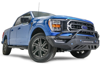 Fab Fours Vengeance front bumper with pre-runner guard on a blue Ford F-150, front passenger-side three-quarter view, showing the pre-runner hoop, light bar and angled end cap