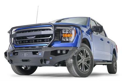 Fab Fours Matrix front bumper with full guard on a blue Ford F-150, front driver-side three-quarter view, showing the full grille guard, light bar and cube light pods