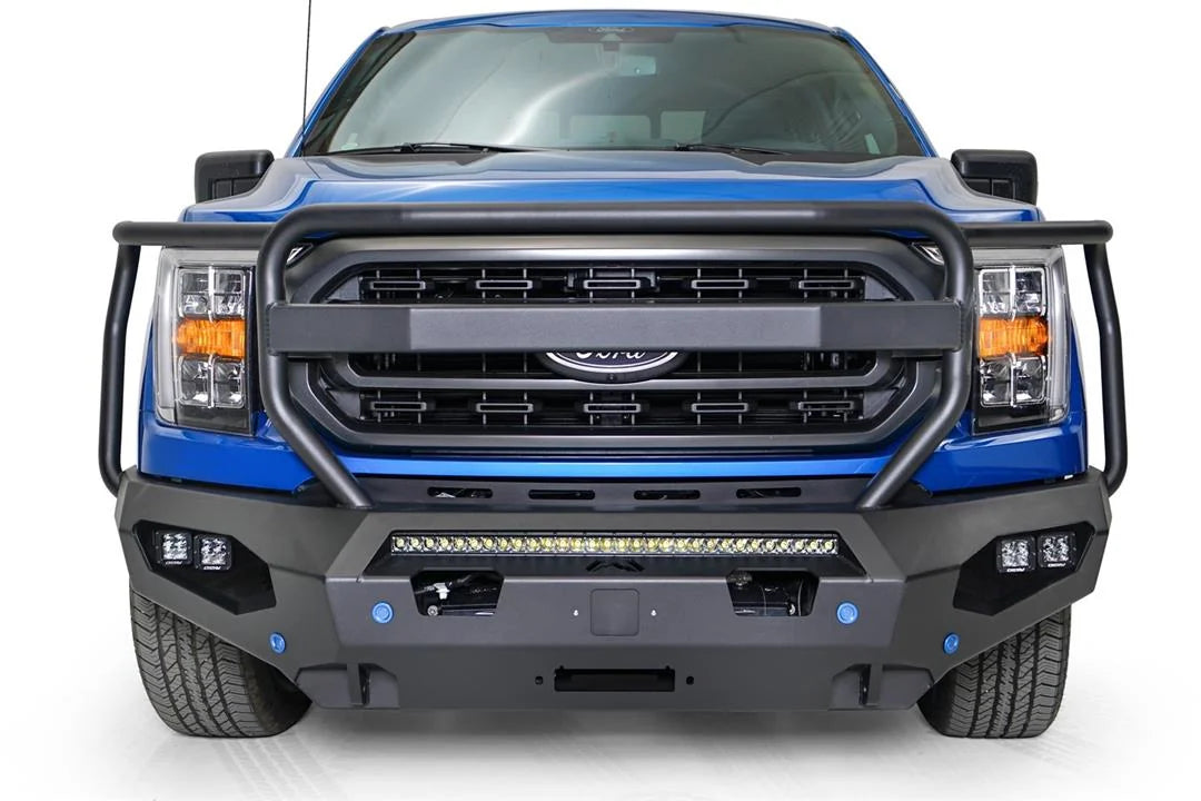 Fab Fours Matrix front bumper with full guard on a blue Ford F-150, straight-on front view, showing the full grille guard, center light bar and cube light pods