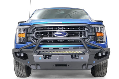 Fab Fours Matrix front bumper with pre-runner guard on a blue Ford F-150, straight-on front view, showing the pre-runner hoop, center light bar and cube light pods