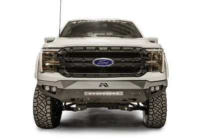 Fab Fours Vengeance front bumper on a white Ford F-150, straight-on front view, showing the center light bar, cube light pods and Fab Fours logo