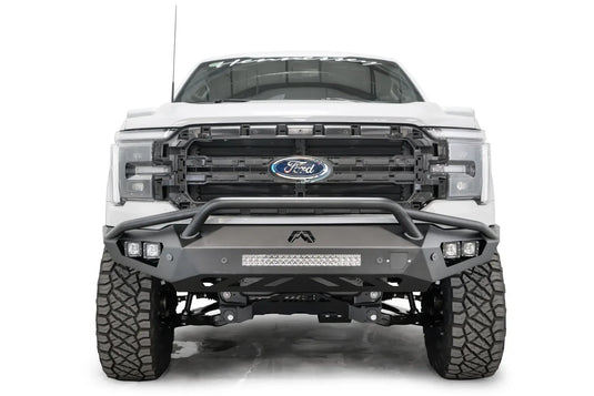 Fab Fours Vengeance front bumper with pre-runner guard on a white Ford F-150, straight-on front view, showing the pre-runner hoop, center light bar and cube light pods