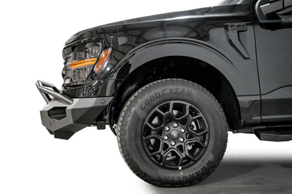 Fab Fours Matrix front bumper with pre-runner guard on a black Ford F-150, close-up of the front corner, showing the pre-runner tube and bumper end cap