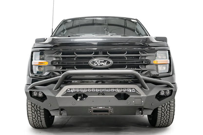 Fab Fours Matrix front bumper with pre-runner guard on a black Ford F-150, straight-on front view, showing the pre-runner hoop, center light bar and winch