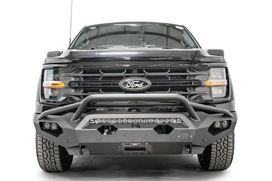 Fab Fours Matrix front bumper with pre-runner guard on a black Ford F-150, straight-on front view, showing the pre-runner hoop, center light bar and winch