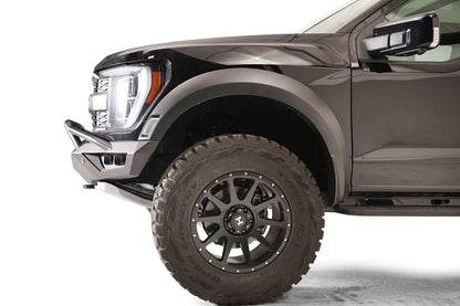 Fab Fours Vengeance front bumper with pre-runner guard on a dark gray Ford Raptor, close-up of the front corner, showing the pre-runner tube and bumper end cap