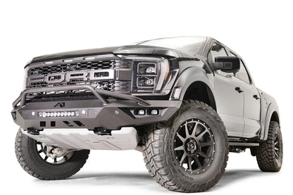 Fab Fours Vengeance front bumper with pre-runner guard on a dark gray Ford Raptor, front driver-side three-quarter view, showing the pre-runner hoop, light bar and angled end cap