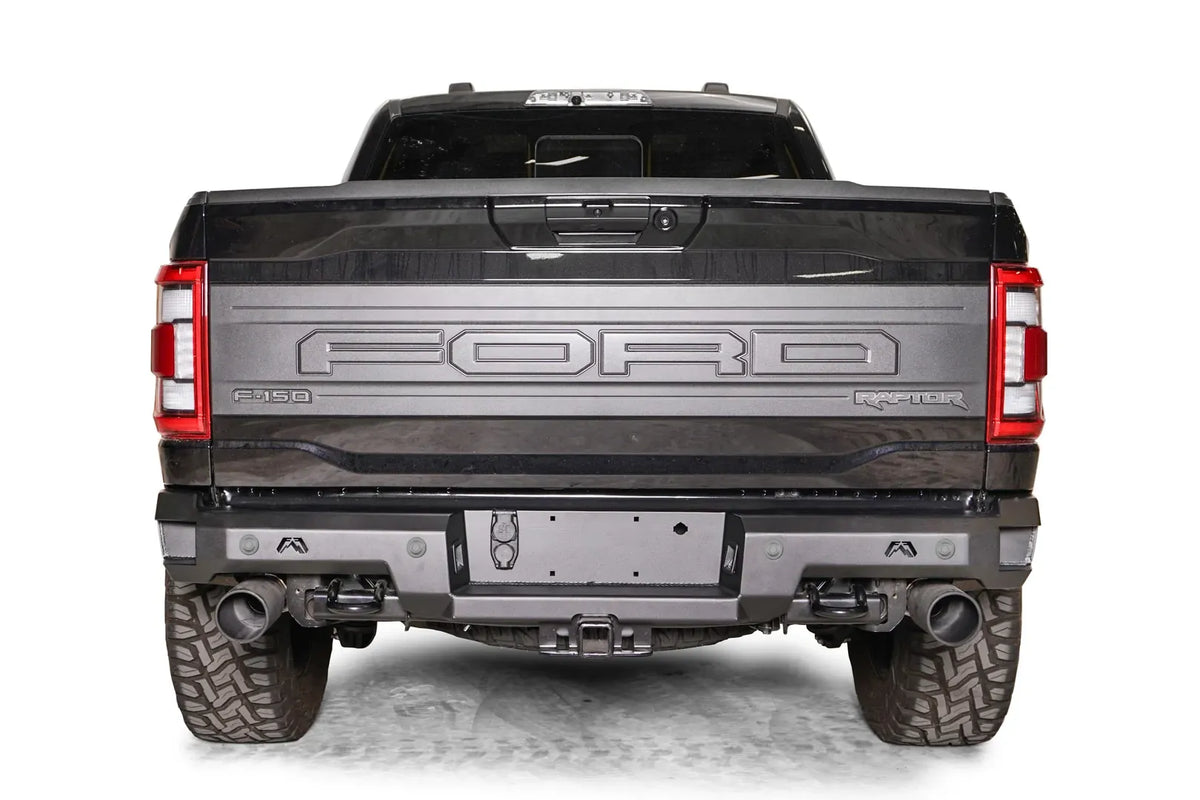 Fab Fours Premium rear bumper on a dark gray Ford F-150 Raptor, straight-on rear view, showing the full-width bumper, recessed license plate mount and dual exhaust cutouts
