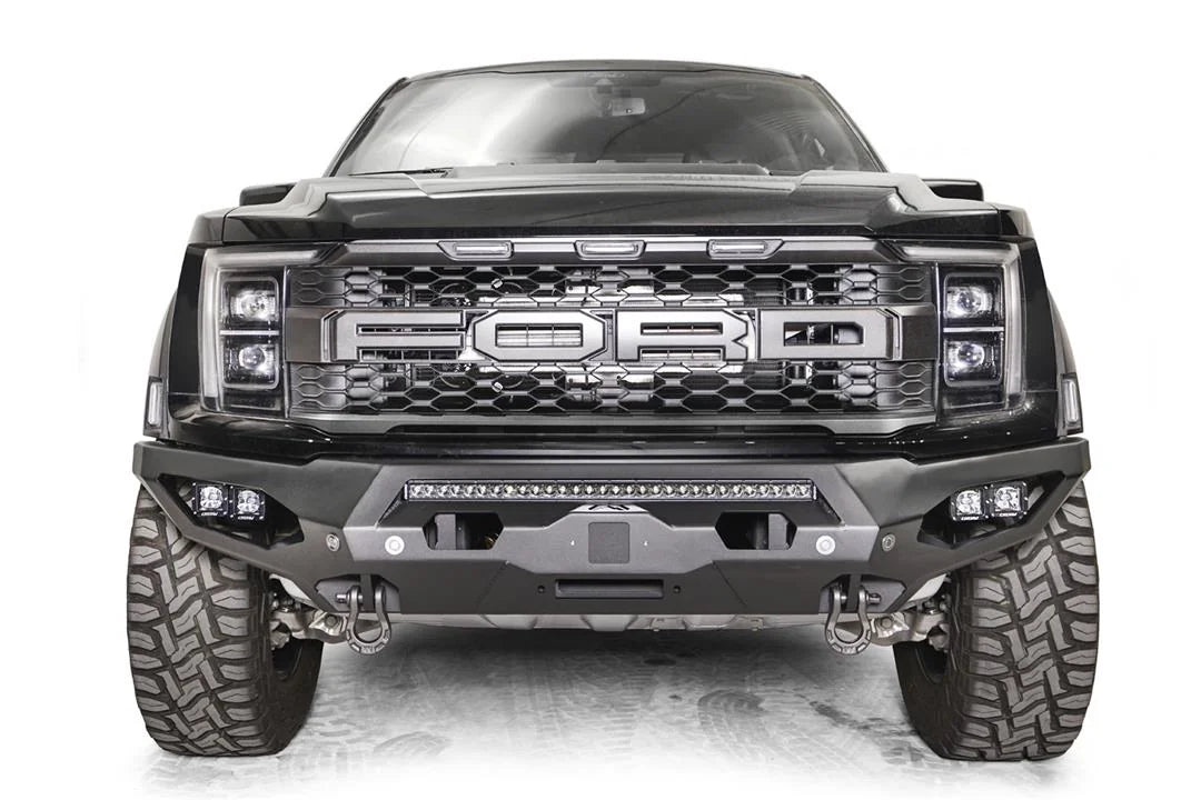 Fab Fours Matrix front bumper on a gray Ford F-150 Raptor, straight-on front view, showing the center light bar, winch plate opening and pod light pockets